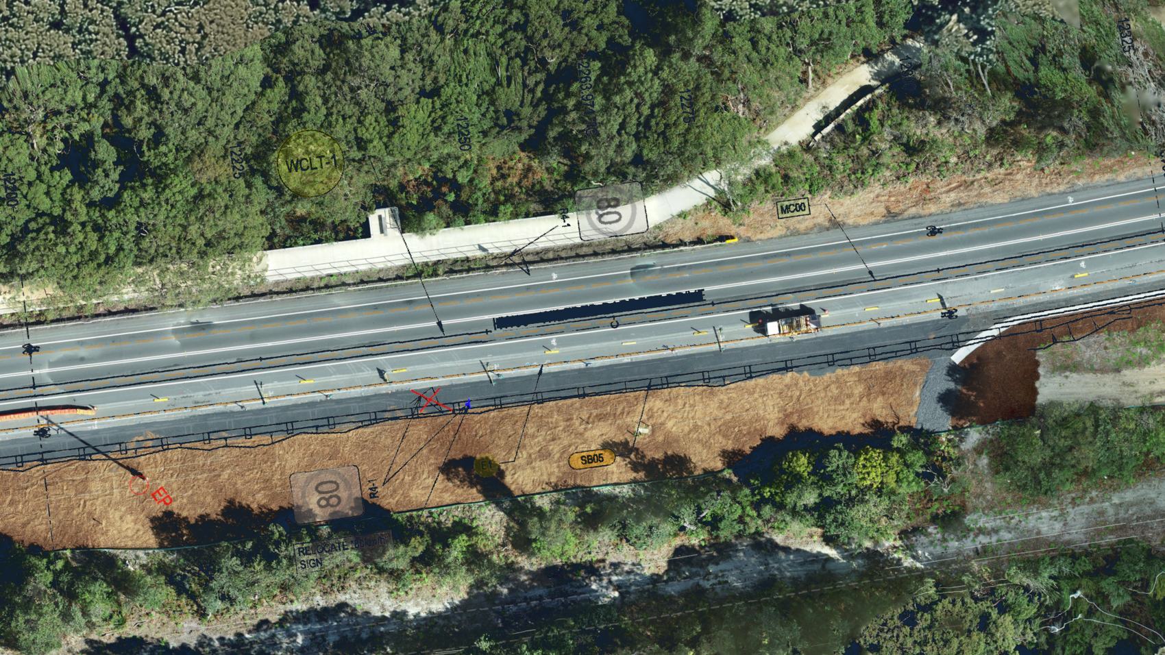 Orthomosaic of a highway widening with the design overlaid — chainages, batter extents, drainage marks and a sign relocation noted against the survey